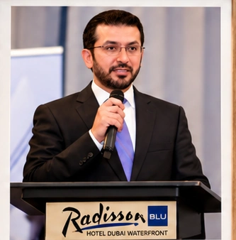 Dr. Mohammad Najafi speaking at a professional event at Radisson Blu Hotel Dubai Waterfront